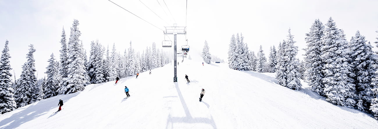 Skiiers coming down Aspen Mountain.