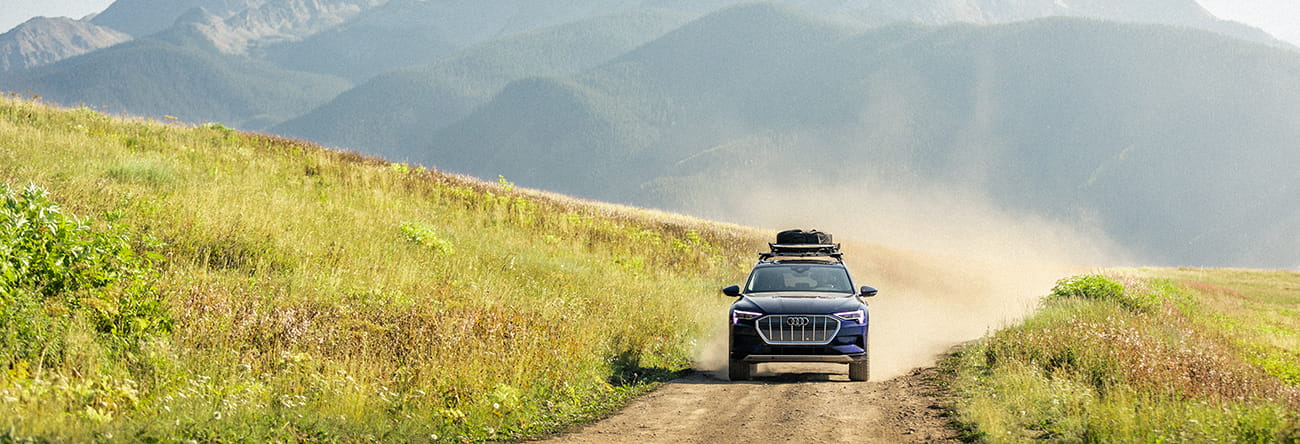 A Little Nell adventure car driving down a dirt road on top of Aspen Mountain.