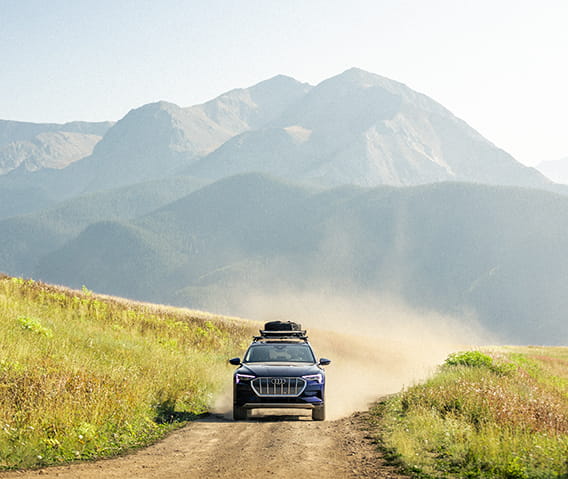 A Little Nell adventure car driving down a dirt road on top of Aspen Mountain.