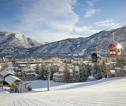 The Silver Queen Gondola and The Little Nell hotel on a sunny winter day.