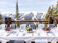 Decorative table on an outdoor patio overlooking the mountains for The Little Nell's Wine Academy.