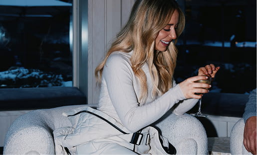 woman in ski clothes with drink
