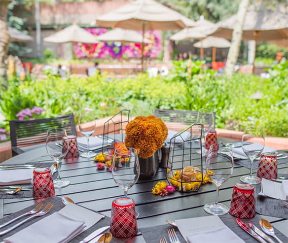 Set table on Element 47's patio with flower arrangements. 