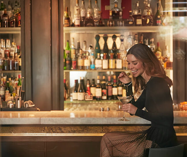 women enjoying a martini at the bar