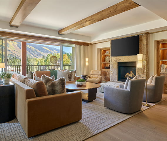 The Residences at The Little Nell living room with cozy couches and a fireplace