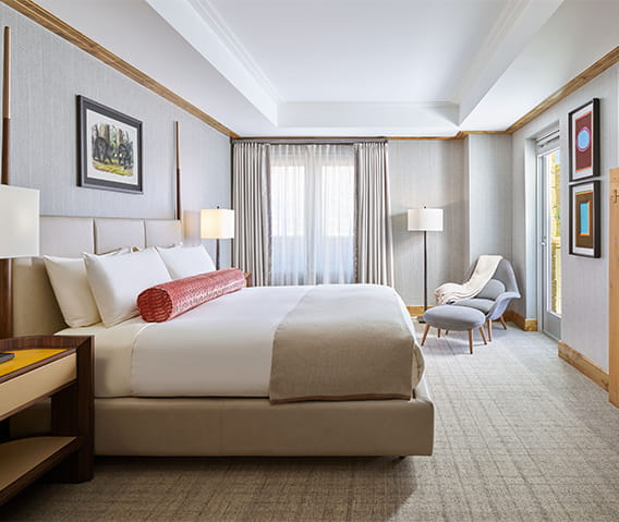 Spacious king bedroom with fireplace and television at The Residences. 