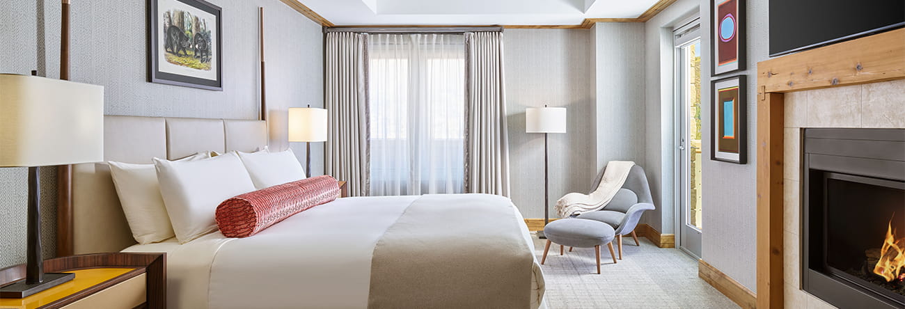 Spacious king bedroom with fireplace and television at The Residences. 