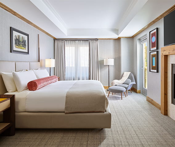 Spacious king bedroom with fireplace and television at The Residences. 