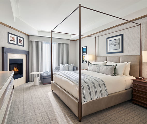 Deluxe bedroom at The Residences with a king bed and fireplace.