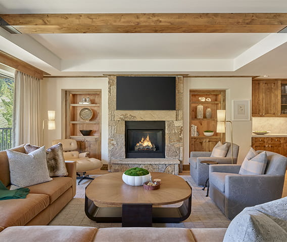 Spacious living room in a Residence at The Little Nell with ample seating area, flat screen TV, and a fireplace. 