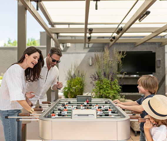 The rooftop garden deck at the Residences at The Little Nell offers activities for the whole family to enjoy, such as a foosball table.