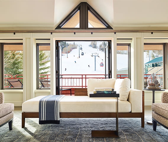 A luxury suite's panoramic window shows views of Aspen Mountain.