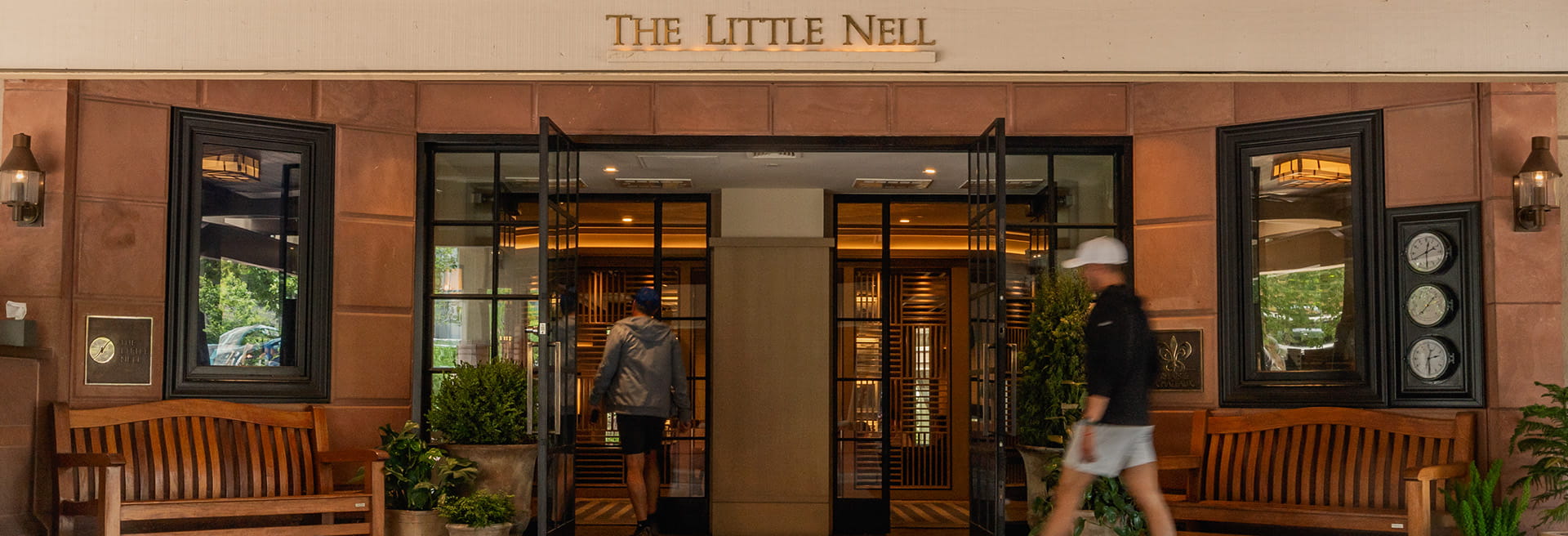 people walking into the little nell hotel entrance