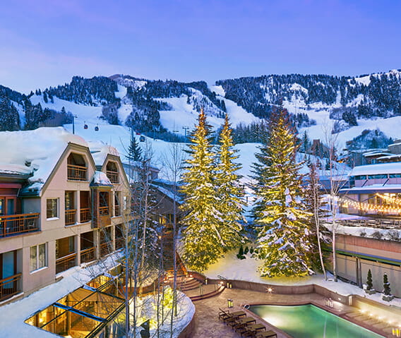 the little nell hotel in the winter with aspen mountain in the background