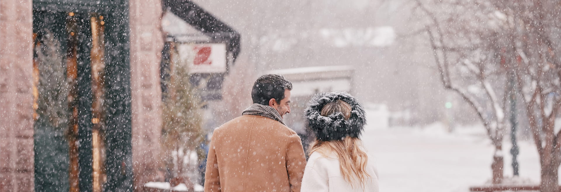 couple walking in downtown aspen in winter