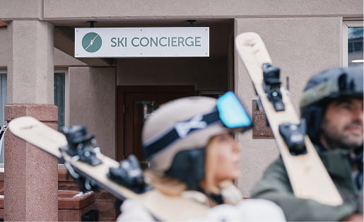 two skiers in front of the ski conceirge