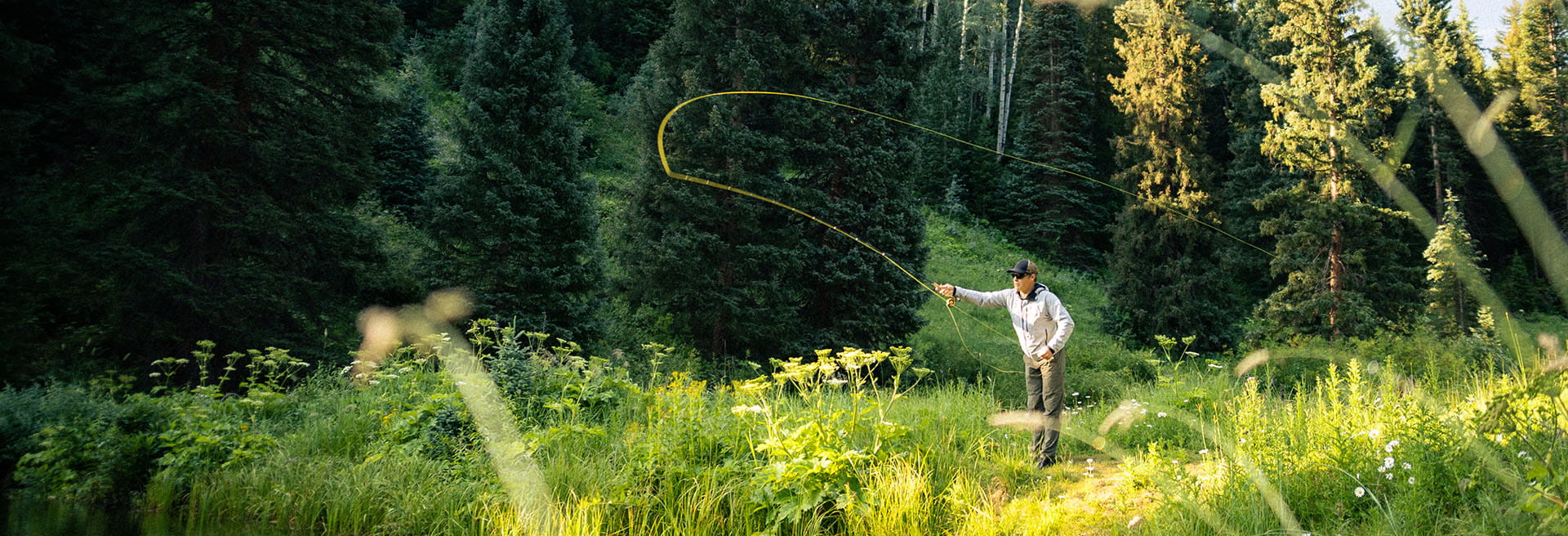 man fly fishing in the mountains