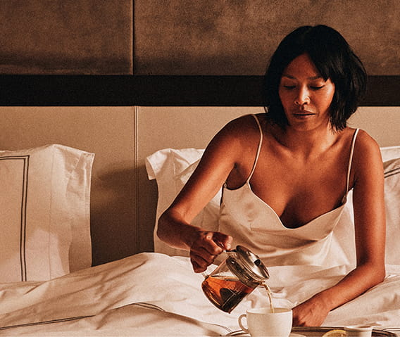 woman on bed with food
