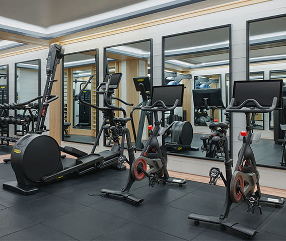 The fitness center at The Little Nell with pelotons and other state of the art equipment.