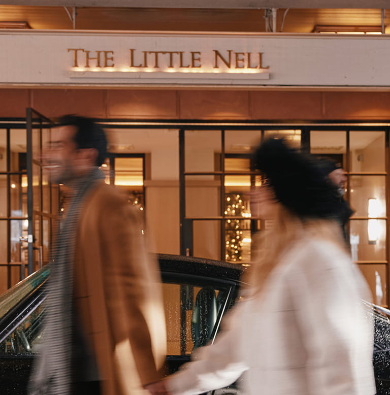 couple walking in front of entrance
