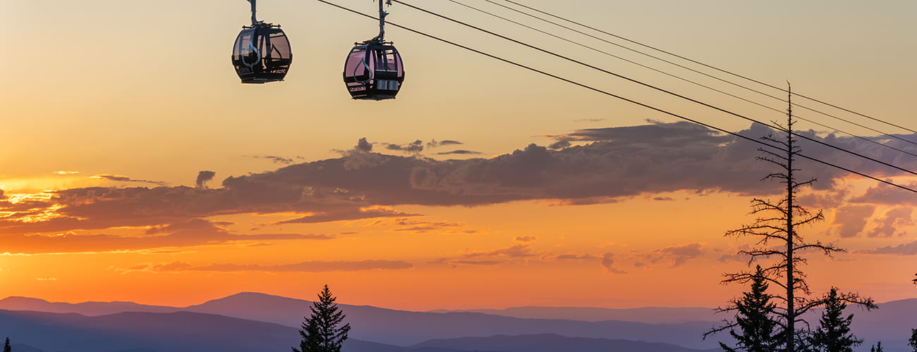 two aspen gondolas at sunset in the summer