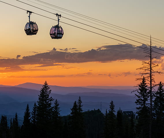 two aspen gondolas at sunset in the summer