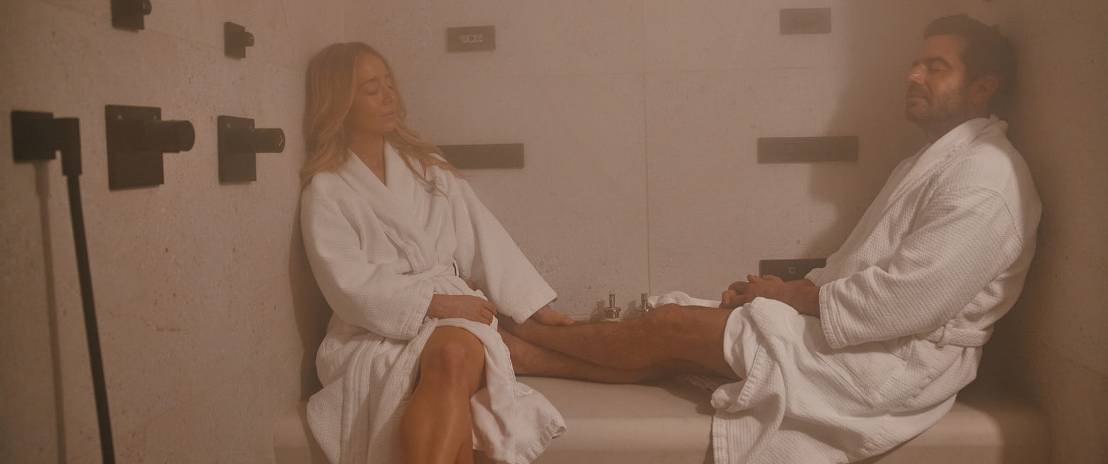 two people in steam room relaxing