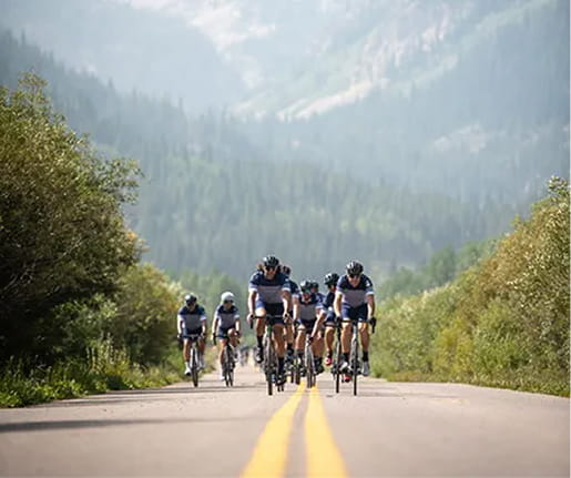 group of cyclists on mountain road