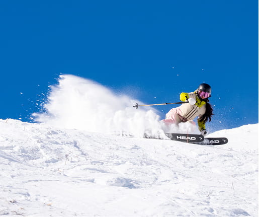 woman shredding down mountain run