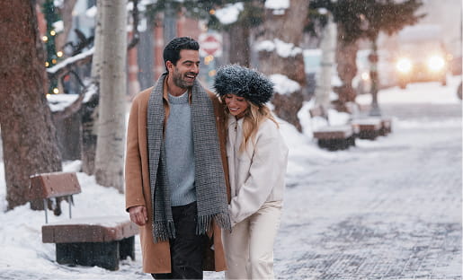 couple walking in snowy aspen downtown