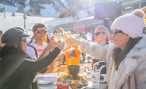 friends toasting champagne outside at ajax for apres ski