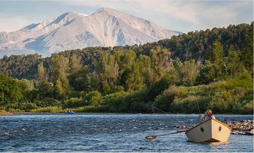 row boat going down roaring fork river