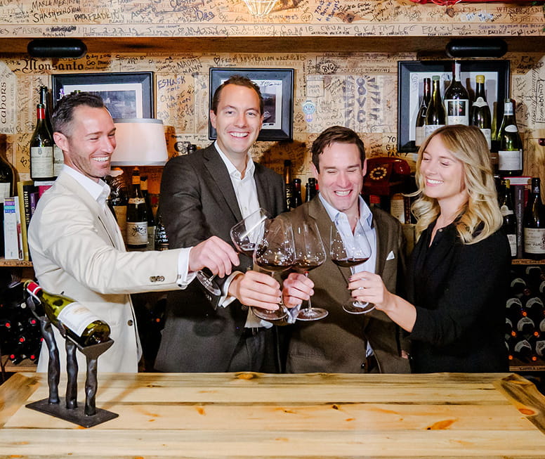 wine team cheerings wine glasses with each other